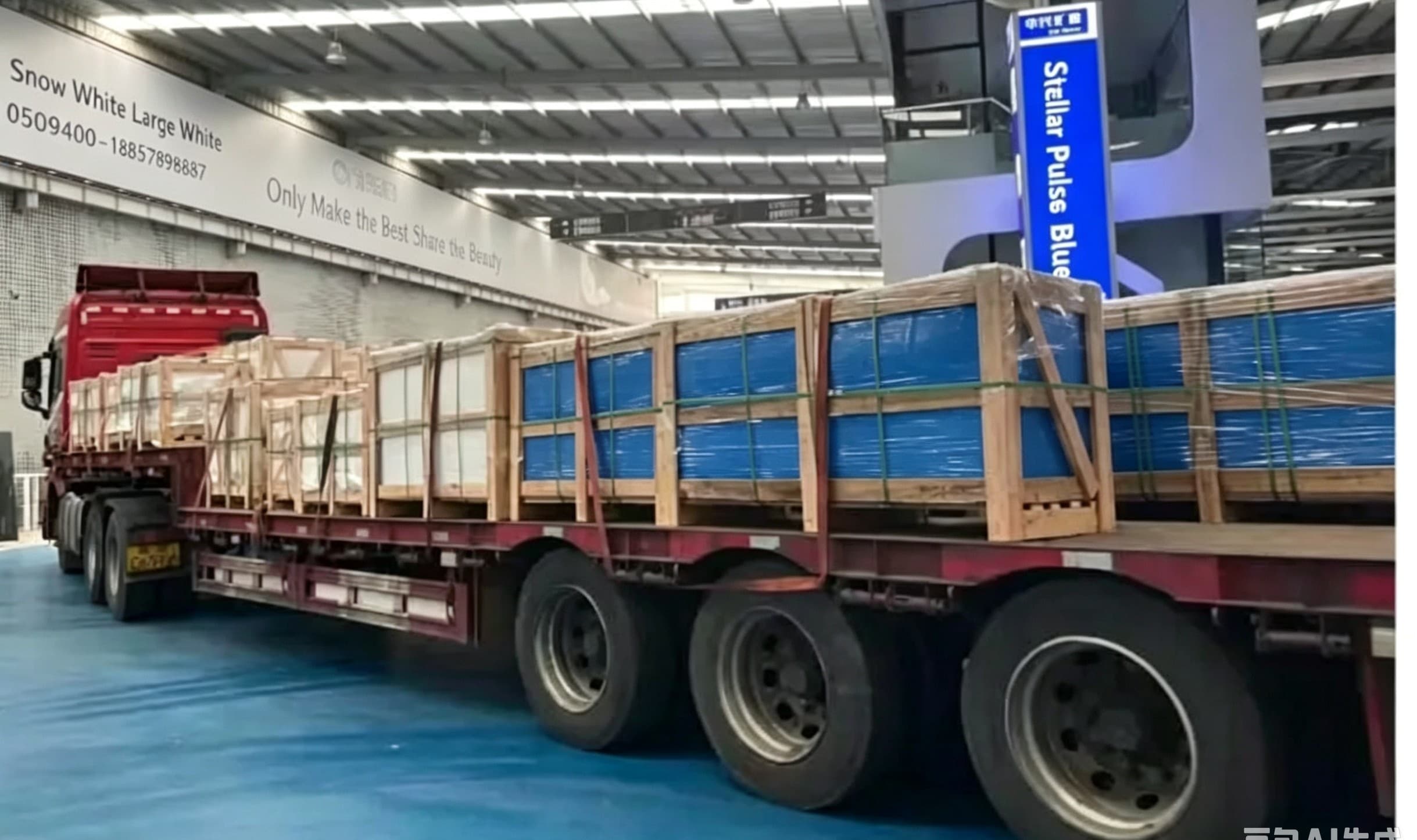 Truck carrying crated blue-wrapped stone products inside a warehouse loading facility